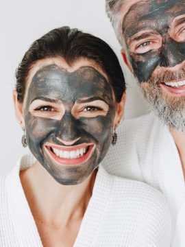 happy-couple-wearing-a-charcoal-mask-AXYBWQ9-scaled.jpg